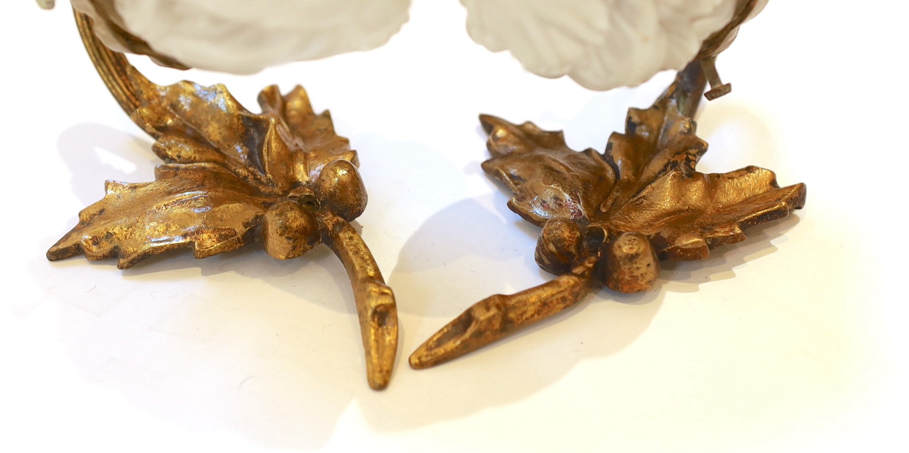 A pair of 1920s brass wall lights with frosted flame glass shades and a pair of brass ribbon back wall lights with lustre shades, height 14cm & height 12cm